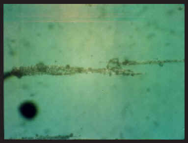 Ferrograph of the SFR 100 treated oil showing a thin band of wear particles